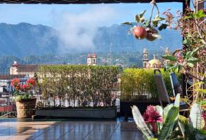 a balcony with plants and a view of a city at Hotel El Eden 2 pers 12 in Zacatlán