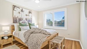 a bedroom with a large bed and a window at Trio by the Sea in Forster