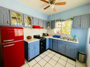 a kitchen with blue cabinets and a red refrigerator at Casa Kante centro histórico 2bed 2Bath parking in San José del Cabo