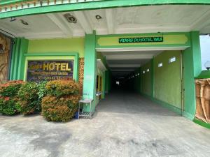 a building with a hotel sign on the side of it at Kasdin Hotel Pati in Pati