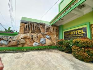 a hotel building with a large wall with a display of fossil teeth at Kasdin Hotel Pati in Pati