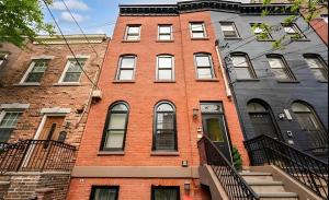 a red brick building with a clock on it at Corporate Housing, Upgraded Condo Downtown Hoboken in Hoboken