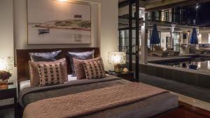 a bedroom with a large bed with pillows at Villa Adenium by Elite Havens in Jimbaran +47 photos