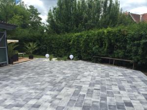 a stone patio with two white balls on it at Enjoyit-WS in Velden am Wörthersee