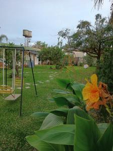 a park with a swing set and a playground at Alojamiento en Villa Elisa in Villa Elisa