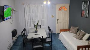 a living room with a table and a couch at Alojamiento en Villa Elisa in Villa Elisa