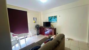 a living room with a couch and a table at Salinas AzulGávea in Salinópolis