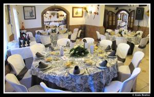 a group of tables with white chairs and tablesearcher at Hotel Enrique Calvillo in El Bosque