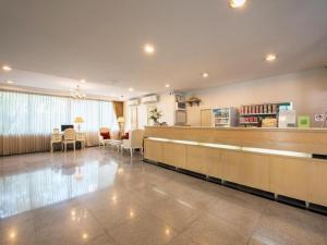 a waiting room with a cash register and a waiting area at Romance Hotel Srinakarin in Bangkok