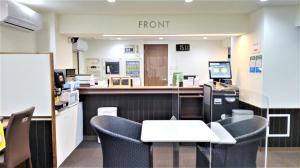 a room with chairs and a counter with a front desk at Ikebukuro Royal Hotel Higashiguchi in Tokyo