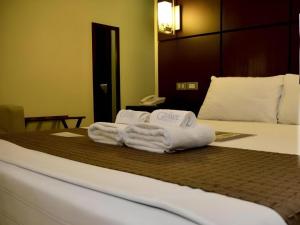 a hotel room with towels on a bed at The Grande Suites in Surigao