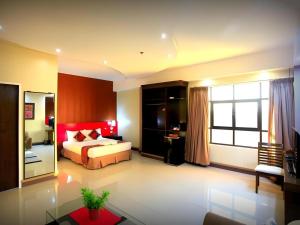 una camera da letto con un letto e una grande finestra di Big Daddy Hotel and Convention Center a Butuan