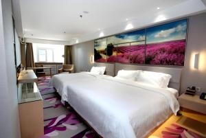 a large white bed in a hotel room with a large painting at Lavande Hotels Changzhi City God Temple in Changzhi +116 photos