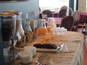 a table topped with plates of food and drinks at Hotel Canto del Mar in La Serena