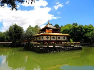 a building in the middle of a body of water at GreenTree Alliance Hotel Lhasa Potala Palace Norbulingka in Lhasa