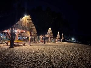 an empty beach at night with a picnic table at Calilayan Cove Beach Resort in Unisan +9 photos