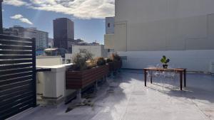 a balcony with benches and a table on a building at Big Penthouse, Bigger Balcony in Wellington