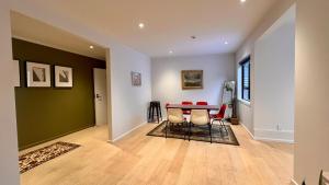 a living room with a red table and chairs at Big Penthouse, Bigger Balcony in Wellington