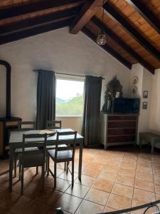 a dining room with a table and chairs and a window at Agriturismo Argentea in Arenzano