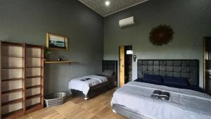 a bedroom with two beds in a room at AK's Surf Resort in Wainapal