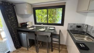 a small kitchen with a table and a window at T1 Boucan Canot Plage in Saint-Paul