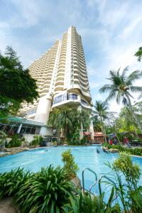 a large building with a swimming pool in front of it at Rainbow paradise at Tanjung Bungah in Tanjung Bungah