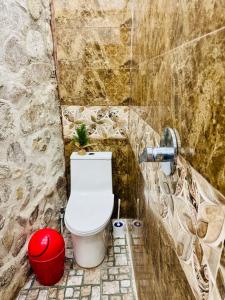 a bathroom with a toilet and a red trash can at Casa Don 20 in San Marcos La Laguna +33 photos