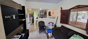 a living room with a couch and a window at Casa de Praia Guajarino - COP 30 in Barcarena