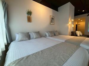 Una cama o camas en una habitación de Neighbor's Hotel 西広島駅前