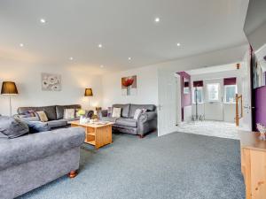 a living room with two couches and a table at Graces Dairy in Wooler