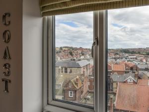 a window with a view of a city at Coast Apartment in Whitby +12 photos