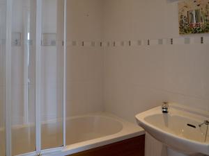 a white bathroom with a shower and a sink at West Park in Hope-Cove