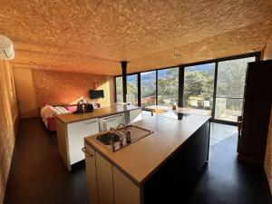 a kitchen with a sink in a room with a bed at The View House Warburton in Warburton