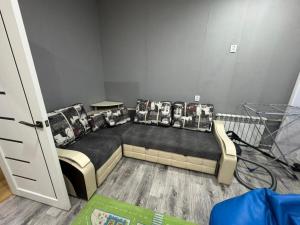 a room with a couch with pillows on it at 2-х комнатная квартира in Balqash