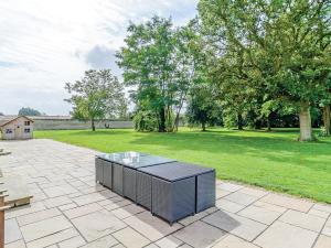 a patio with a table in the middle of a park at Lode Hall in Upwell +22 photos