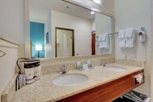 un bagno dell'hotel con due lavandini e un grande specchio di Best Western Liberty Inn DuPont JBLM a DuPont