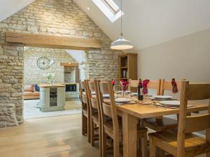 a kitchen and dining room with a wooden table and chairs at The Stables in Heydour
