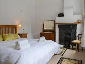 a bedroom with a bed with towels on it at The Mistress' House in Hunstanton