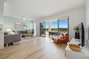 a living room with a couch and a table at Sunrise Cove 9 - Creekfront on Cudgen Creek in Kingscliff