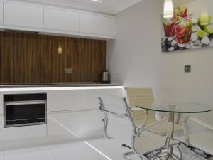 a kitchen with a table and a glass table at Hollies Cottage 10- Ukc4536 in Martock +14 photos