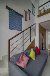 a couch with colorful pillows on it in a living room at Nusa Djiwa in Tanah Lot +18 photos
