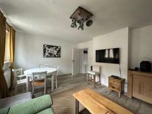 a living room with a table and a dining room at Red Bike Apart's in Opole