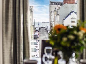 a view from a window of a street with cars at Dyma Y Bywyd in Tenby