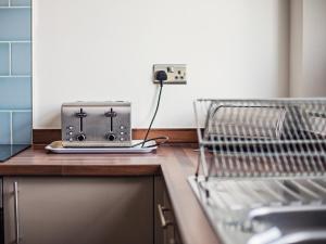 a toaster sitting on a counter in a kitchen at Dyma Y Bywyd in Tenby +13 photos