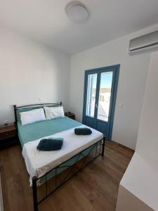 a bedroom with a bed with two pillows on it at #9 Lipsi Port Apartment - Gerani No#9 in Lipsoi +2 photos