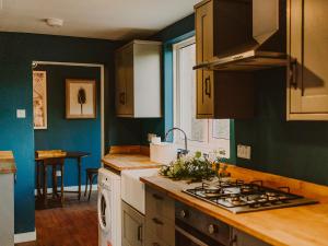 a kitchen with a sink and a stove top oven at Rose Blair Lodge - Uk31045 in Portpatrick +31 photos
