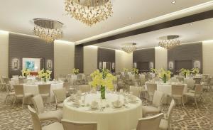 a banquet hall with white tables and chairs and chandeliers at Zota Beach Resort in Longboat Key +37 photos