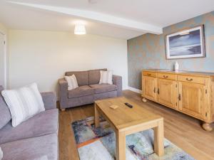 a living room with a couch and a table at Country View - Uk38223 in Ashby cum Fenby