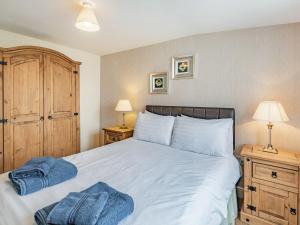 a bedroom with a large bed with two night stands at Country View - Uk38223 in Ashby cum Fenby +7 photos