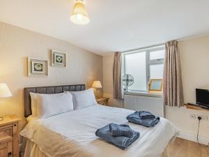 a bedroom with a bed with two towels on it at Country View - Uk38223 in Ashby cum Fenby